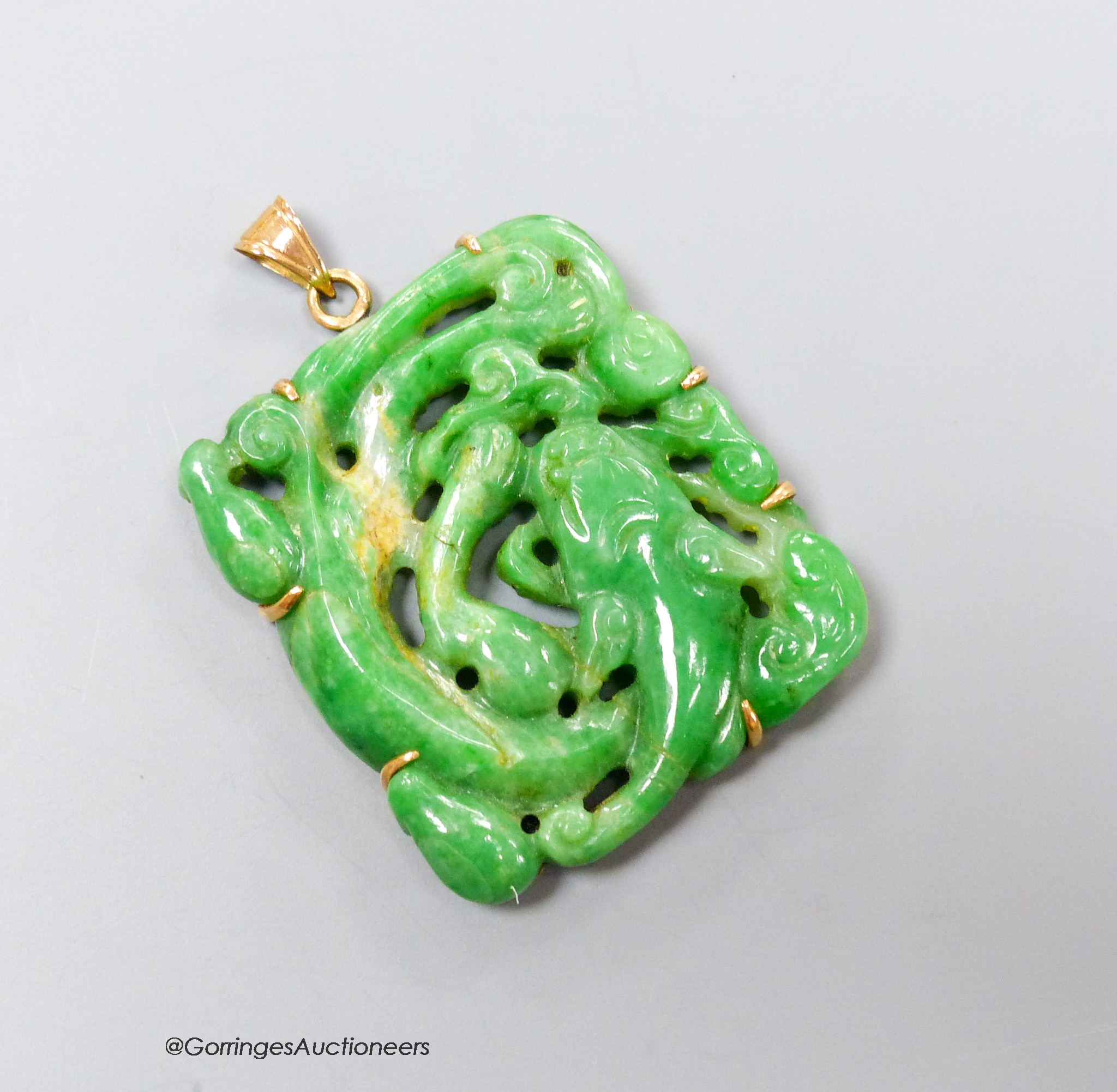 A yellow metal mounted jade pendant, carved with a fish, 37mm, gross weight 15.2 grams.